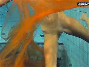 Yellow and red clothed teen underwater